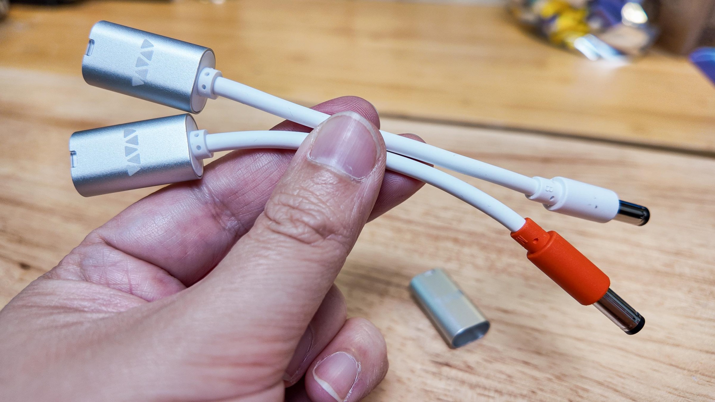 These are both the same size barrel jack, but the orange one is wired center-negative.