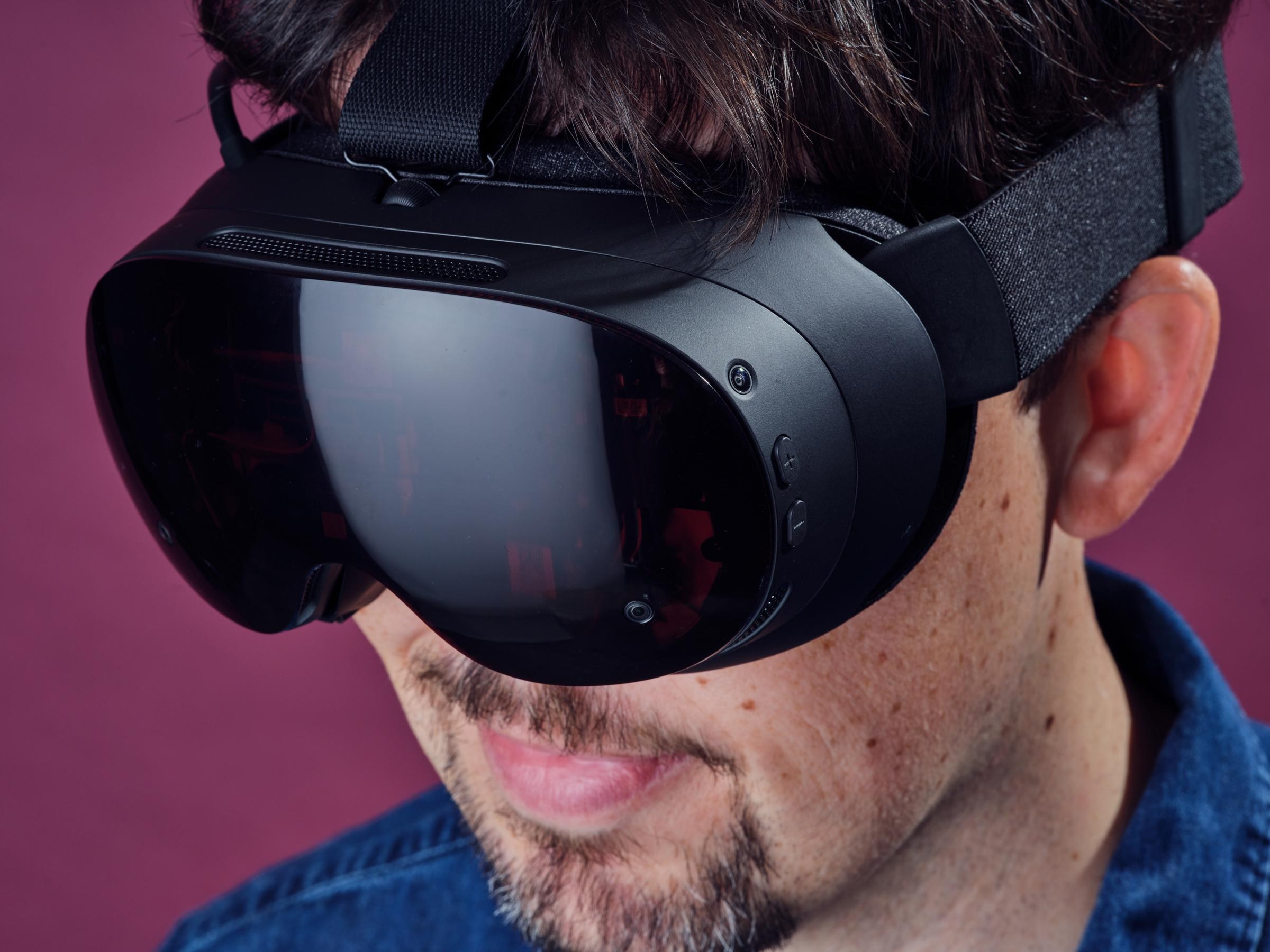A look at the Steam Frame headset on Sean’s face with him looking down, to catch more reflection on its glossy front lens. Close up, we can see two of the Frame’s passthrough cameras, and its volume buttons.