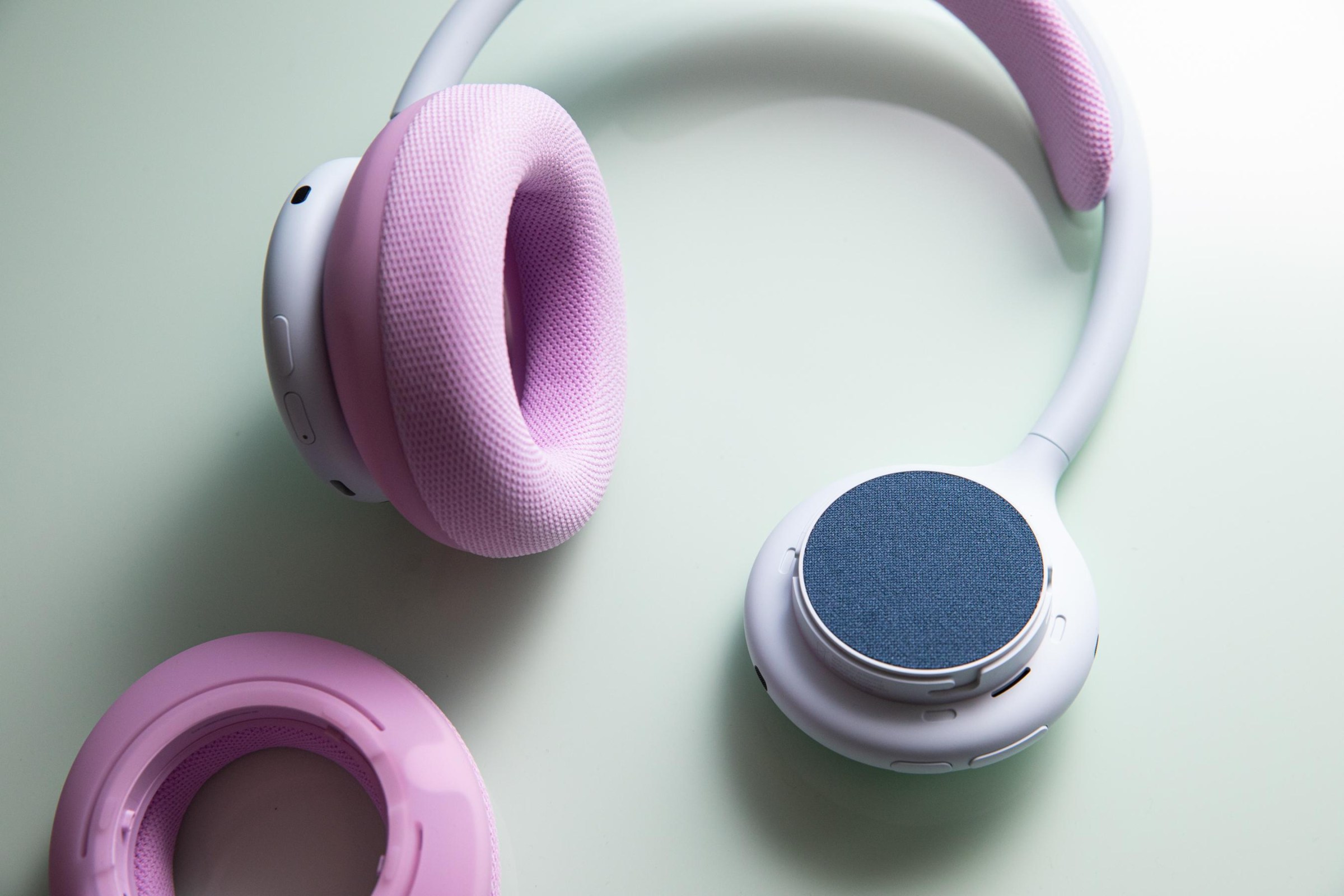 The Beats 360 headphones in white and pink with one ear cup removed.
