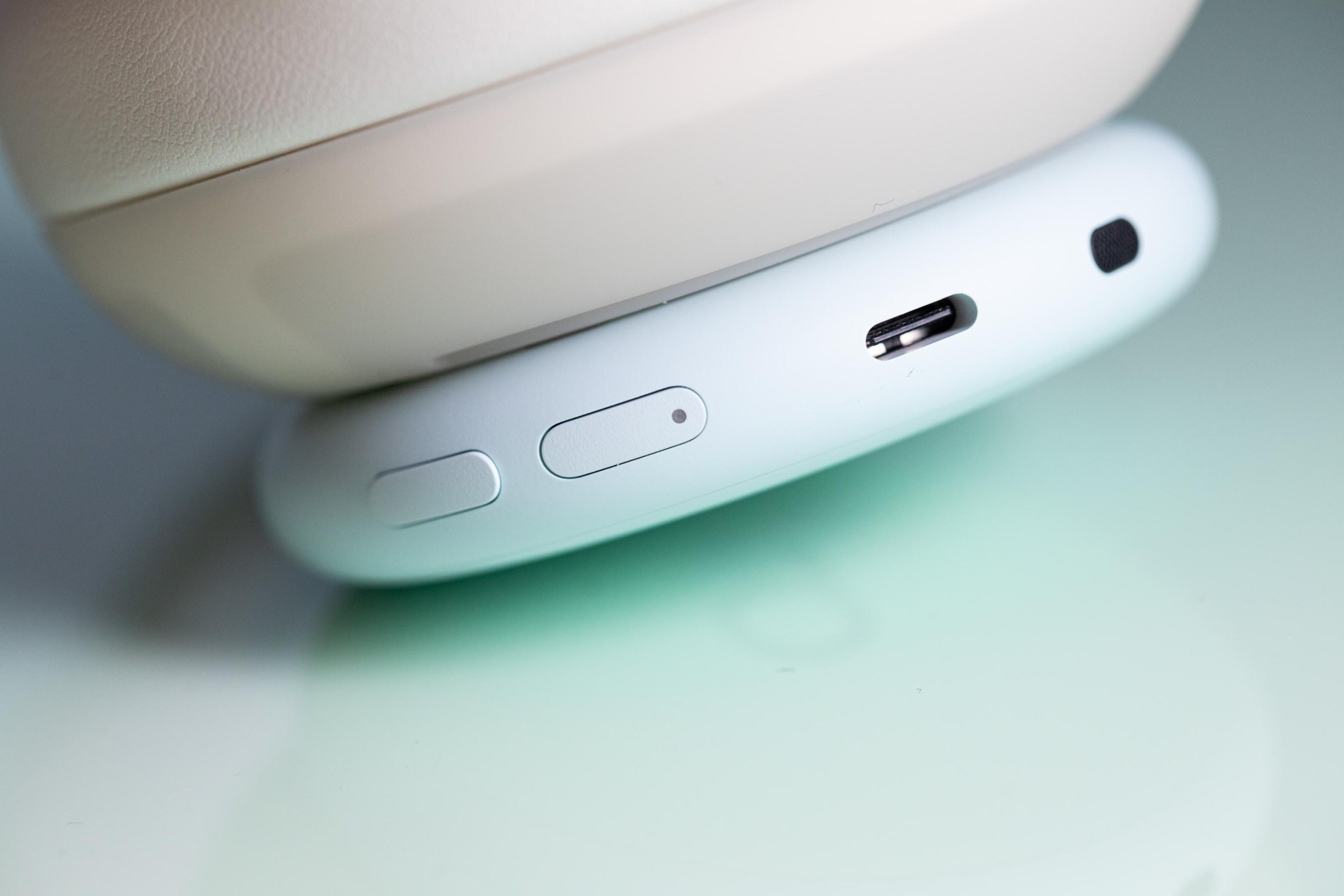 A closeup of the USB-C charge port and buttons on the Beats 360 headphones.