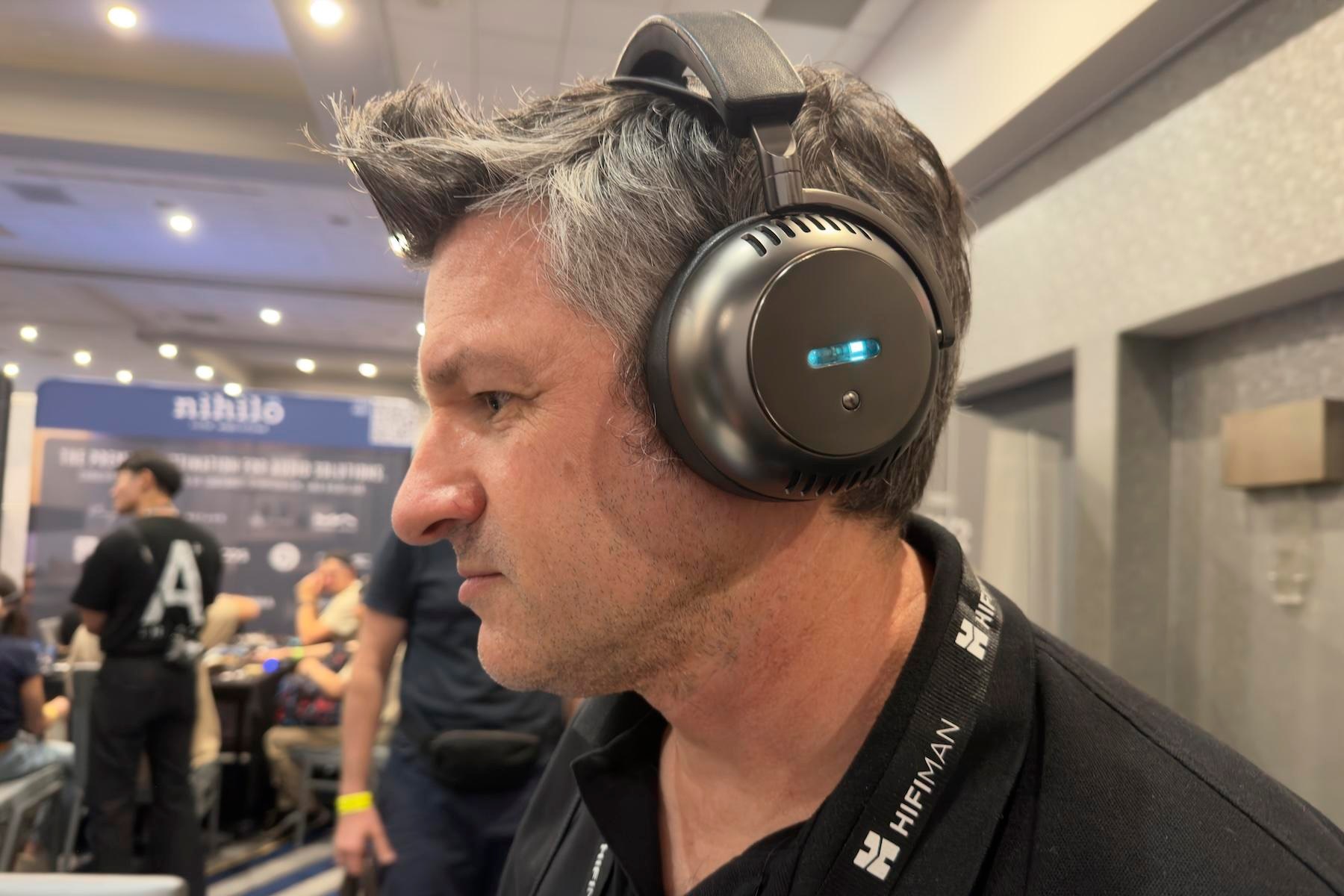 A man listening to the Ecouter TH2 headphones at CanJam SoCal 2026.