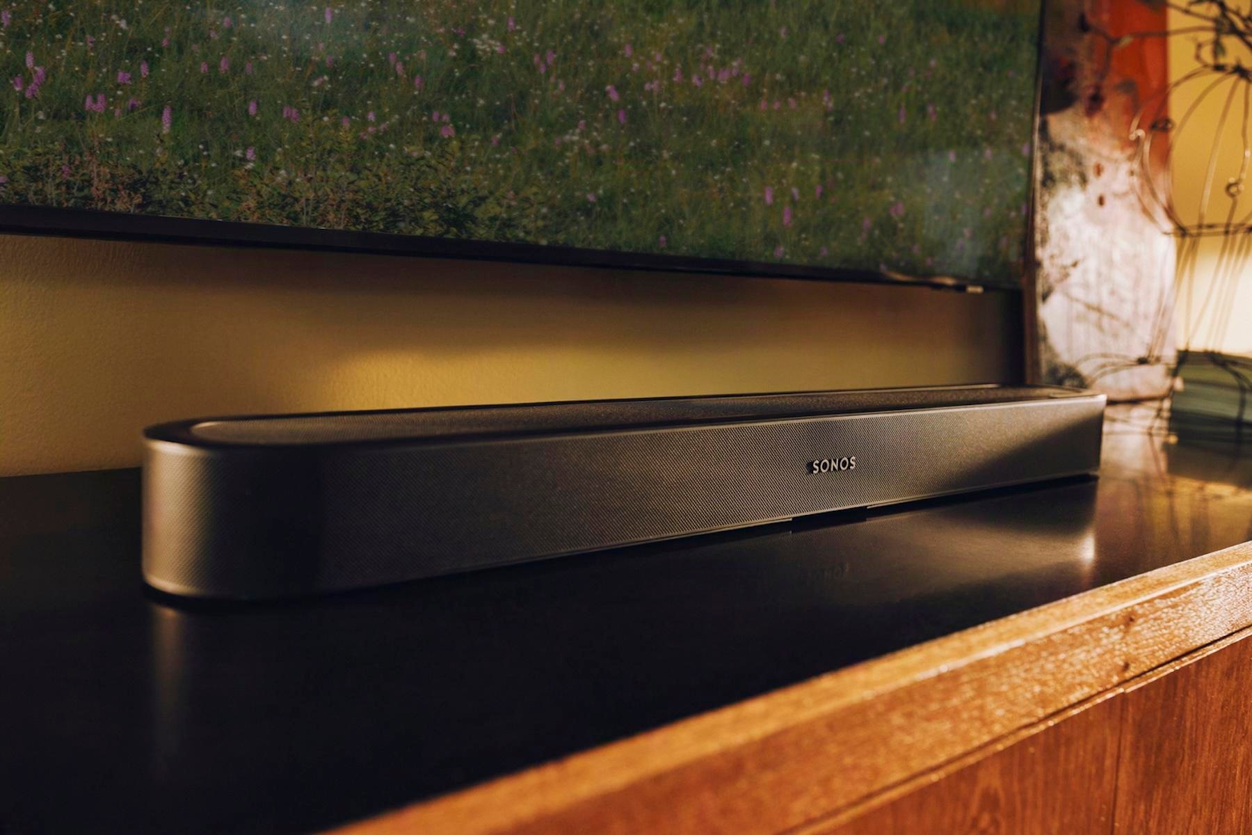 An angled shot of the Sonos Beam Ultra in black on a table under a TV.